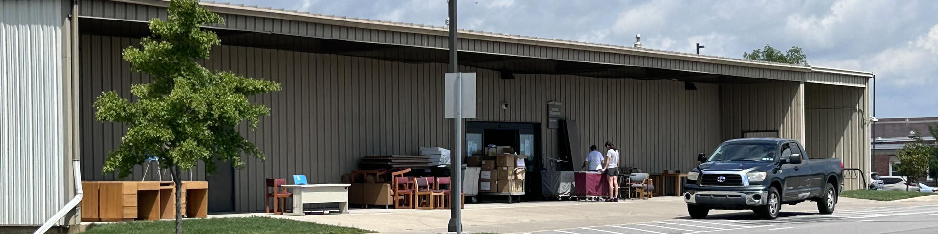 front of the Lion Surplus building with a truck parked outside