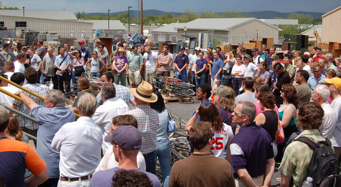 Lion Surplus auction with a lot of people standing around and bikes up for auction